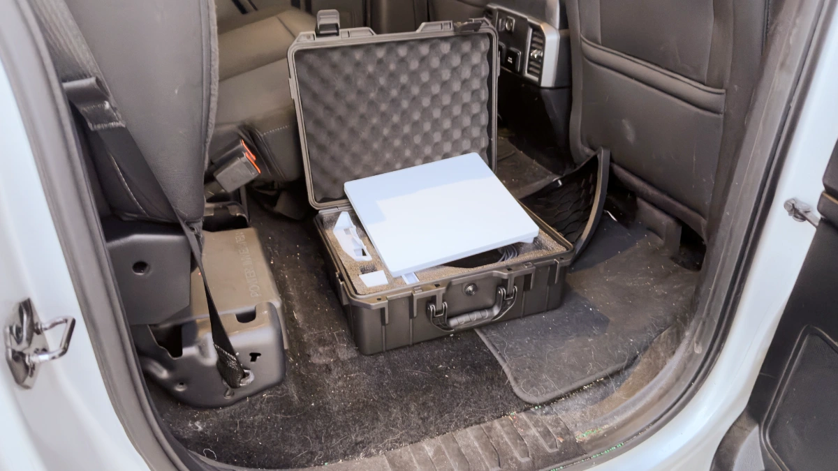 a photo of my hard case and starlink mini in the backseat of my truck