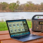 Editing photos on a laptop with power provided by a Jackery power unit